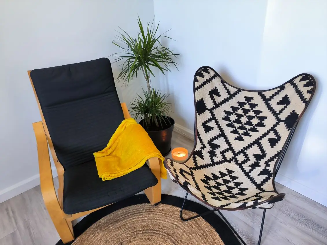 Deux fauteuils face à face sur un tapis de jute, dans la lumière du jour